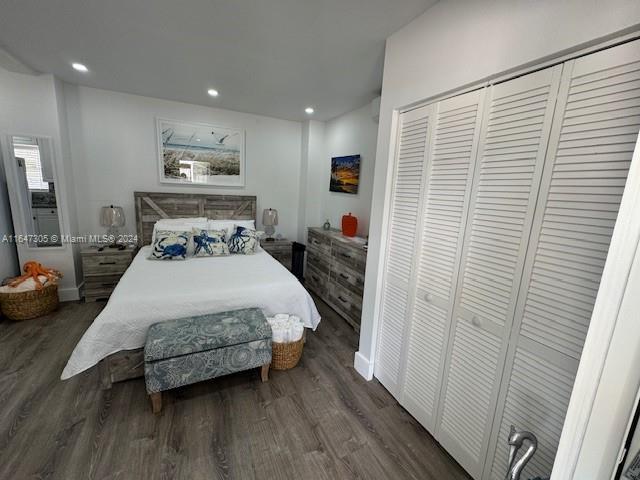 bedroom with a closet and dark hardwood / wood-style floors