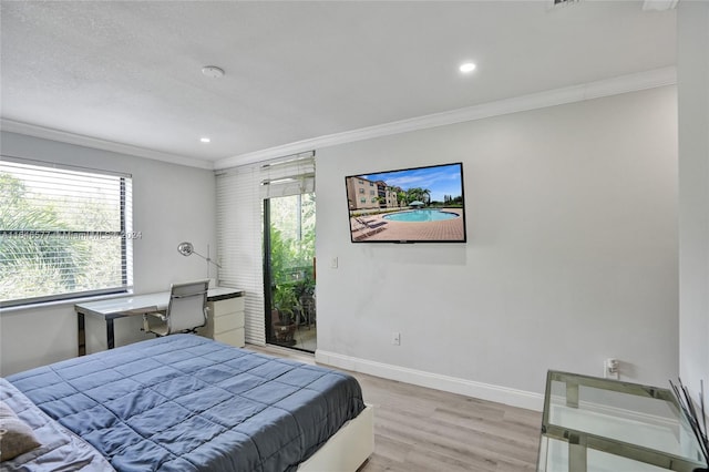 bedroom featuring crown molding, multiple windows, and light wood-type flooring