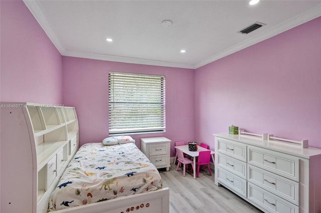 bedroom featuring light hardwood / wood-style floors and ornamental molding