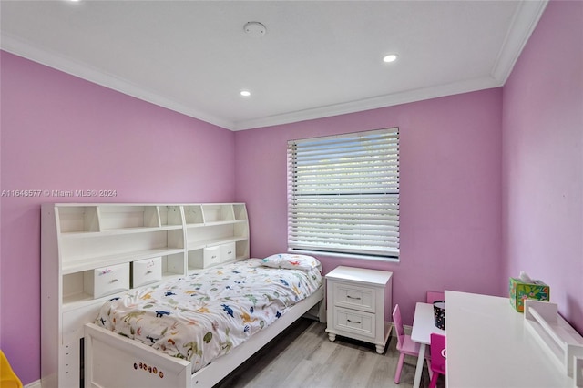 bedroom with light hardwood / wood-style flooring and ornamental molding