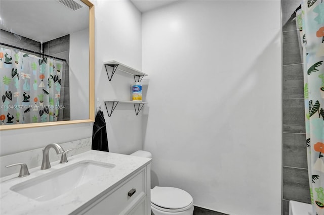 bathroom featuring toilet, vanity, and curtained shower