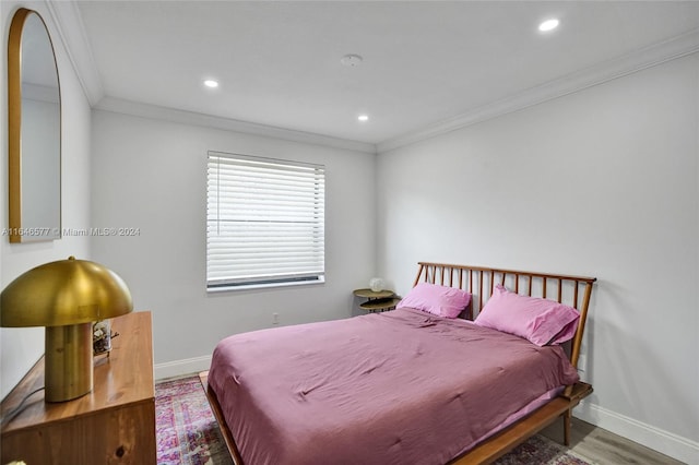 bedroom featuring light wood-type flooring and ornamental molding