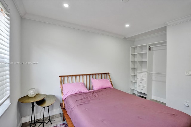 bedroom with ornamental molding and wood-type flooring