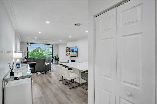 home office featuring light wood-type flooring and crown molding