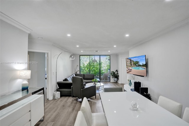 dining space featuring light hardwood / wood-style flooring and ornamental molding