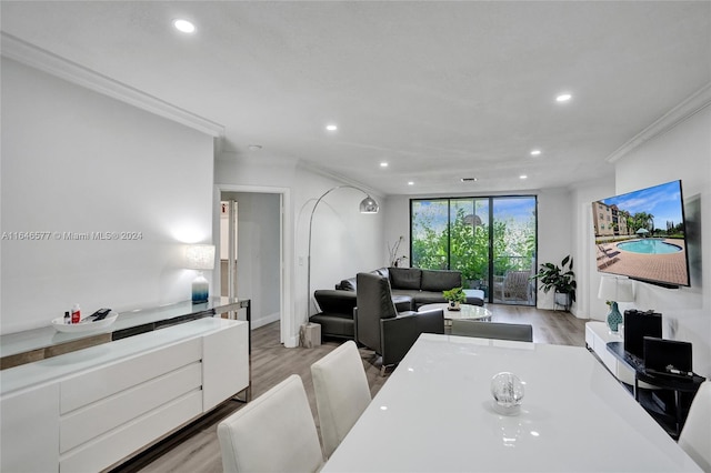 dining space with light hardwood / wood-style flooring and crown molding