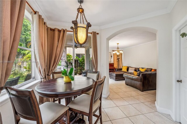 14107 SW 155th St, Miami, FL 33177 - dining room with arched walkways, light tile patterned flooring, a chandelier, and ornamental molding