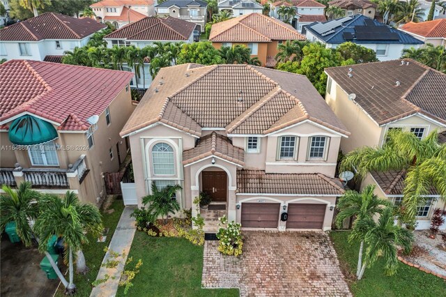 14107 SW 155th St, Miami, FL 33177 - mediterranean / spanish-style home with a tiled roof, a residential view, stucco siding, driveway, and an attached garage
