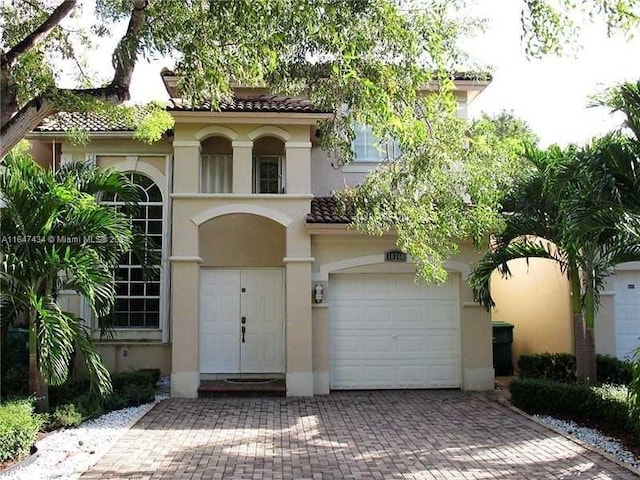 mediterranean / spanish-style home featuring a garage