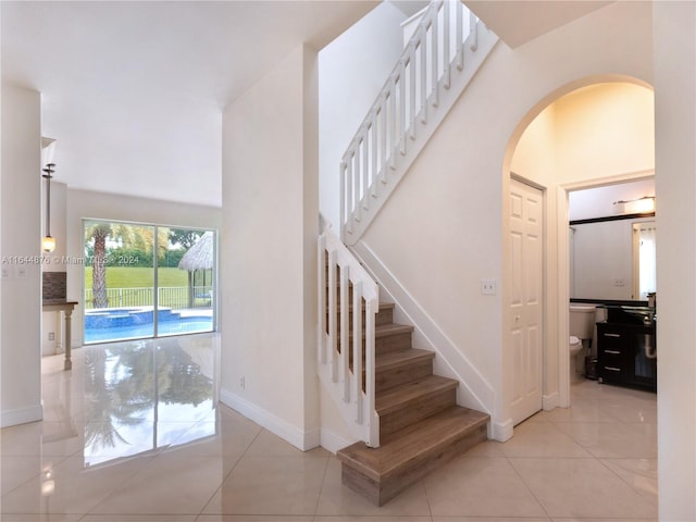 staircase featuring tile patterned floors