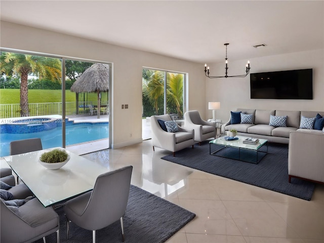 tiled living room with a wealth of natural light and a notable chandelier