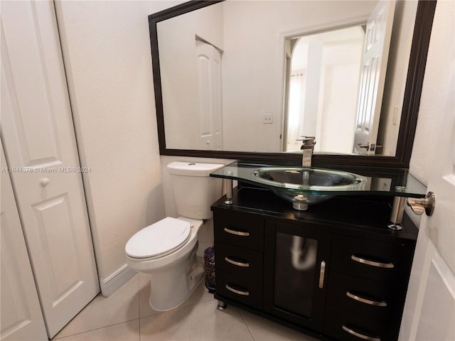 bathroom featuring toilet, vanity, and tile patterned floors