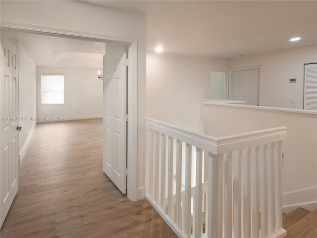 corridor with hardwood / wood-style floors