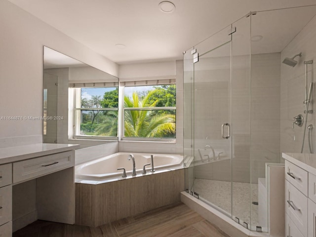 bathroom featuring independent shower and bath and vanity