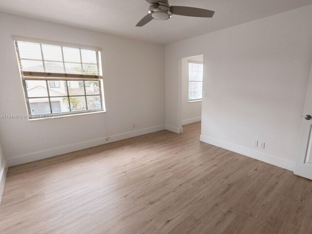 spare room featuring light hardwood / wood-style flooring and ceiling fan