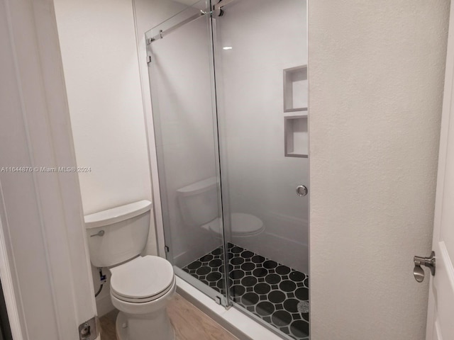 bathroom with toilet and walk in shower