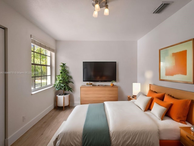 bedroom with light hardwood / wood-style floors