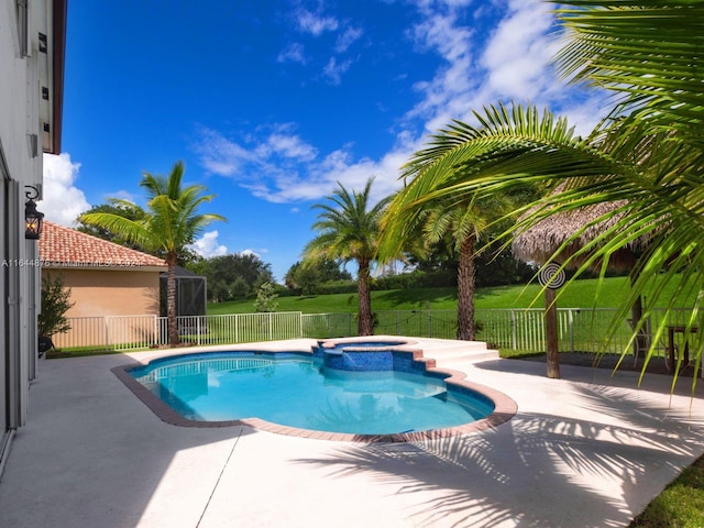 view of pool with an in ground hot tub and a patio