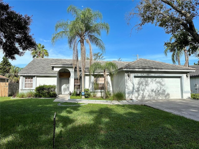 ranch-style house featuring a garage and a front yard