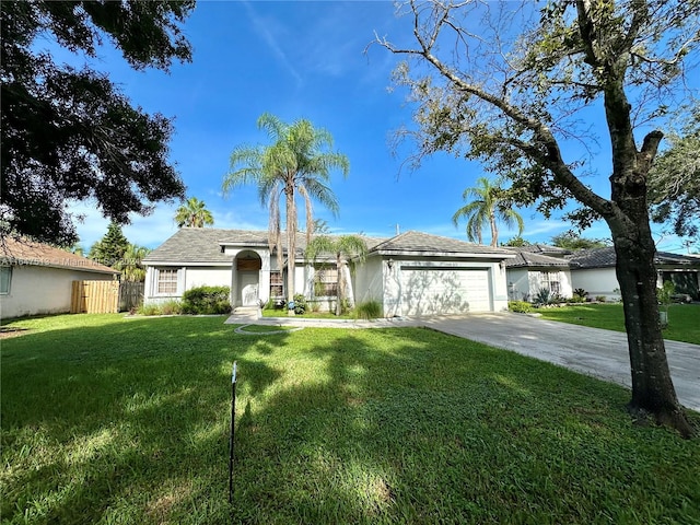 ranch-style home with a garage and a front lawn