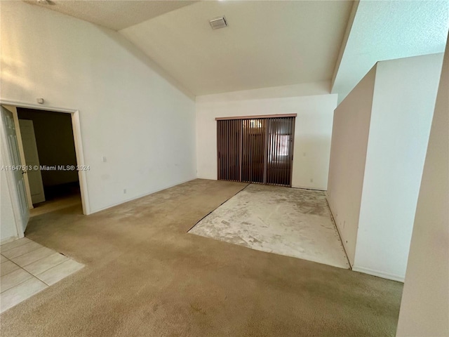 interior space with light colored carpet and lofted ceiling