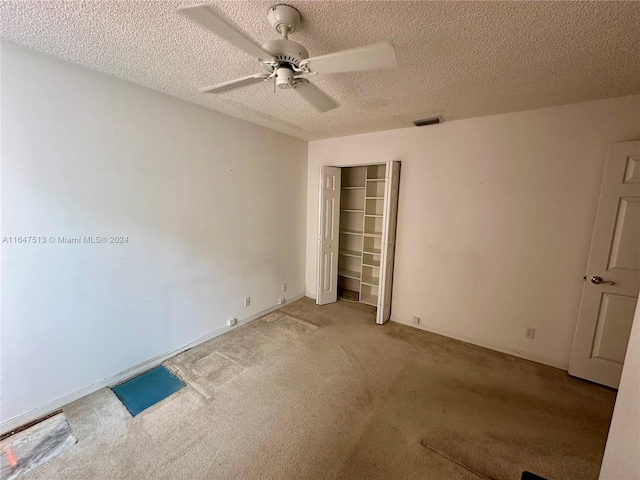 unfurnished bedroom with ceiling fan, a closet, and carpet