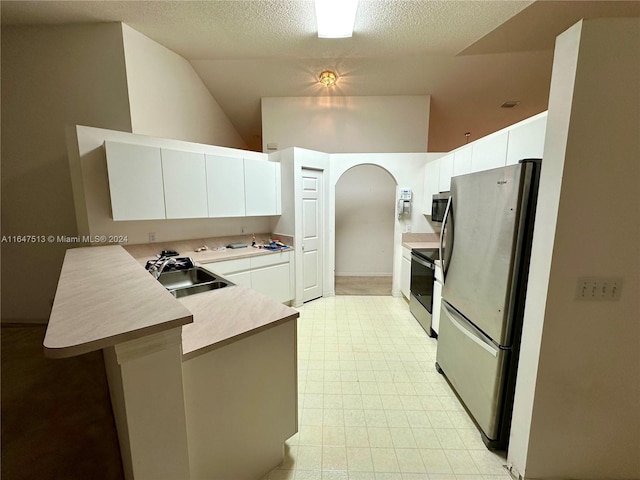 kitchen with stainless steel appliances, white cabinetry, sink, light tile patterned floors, and kitchen peninsula