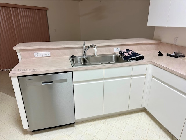 kitchen with stainless steel dishwasher, white cabinetry, light tile patterned floors, sink, and kitchen peninsula