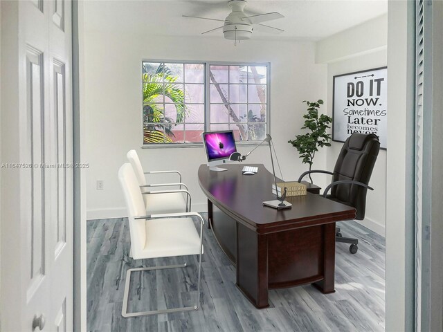 office space with wood finished floors, a ceiling fan, and baseboards