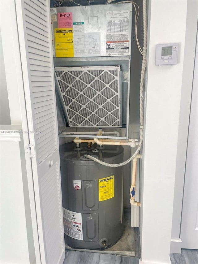 utility room featuring electric water heater