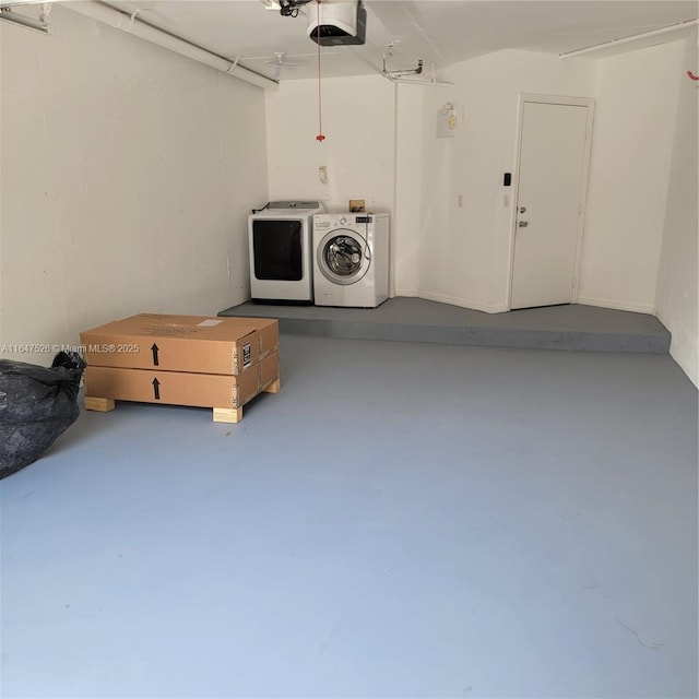 garage featuring independent washer and dryer and a garage door opener