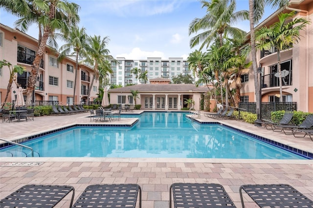 pool featuring a patio area and fence