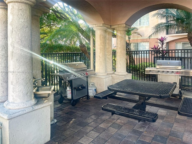 view of patio / terrace featuring a grill and a sink