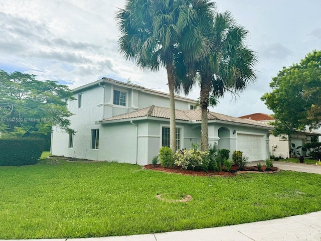 view of front facade with a garage and a front lawn