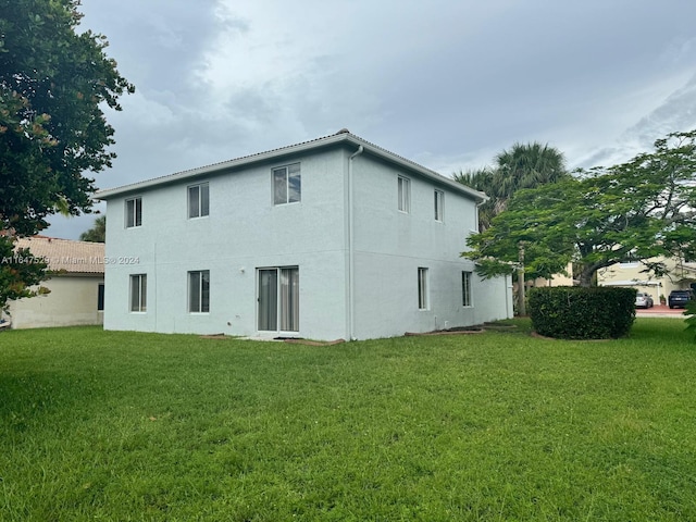 rear view of house with a yard