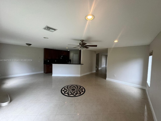 unfurnished living room with light tile patterned floors and ceiling fan