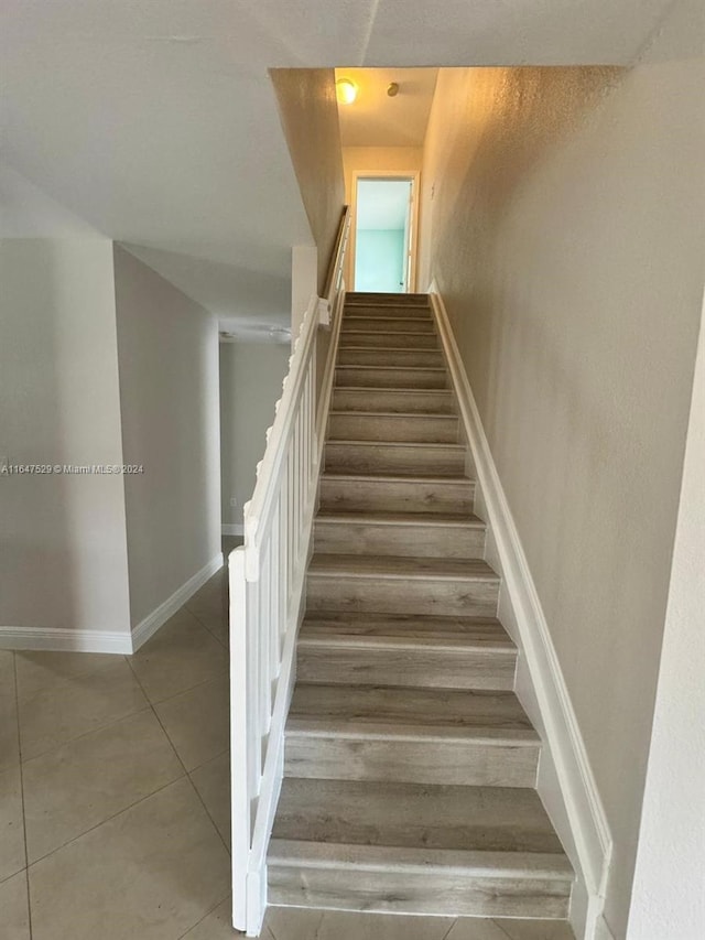 staircase featuring hardwood / wood-style floors