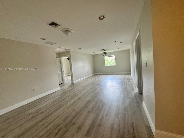 spare room featuring ceiling fan and hardwood / wood-style flooring