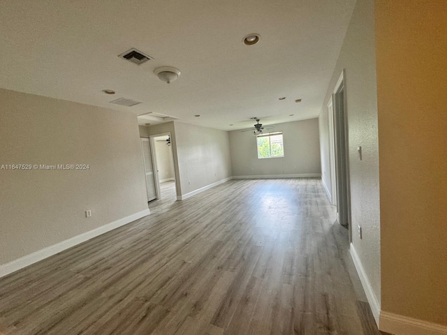 unfurnished room with ceiling fan and hardwood / wood-style floors