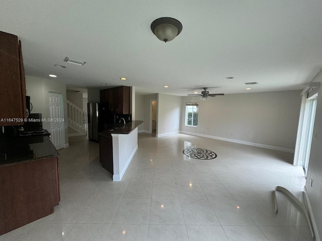 kitchen with stainless steel fridge with ice dispenser, sink, light tile patterned floors, and ceiling fan