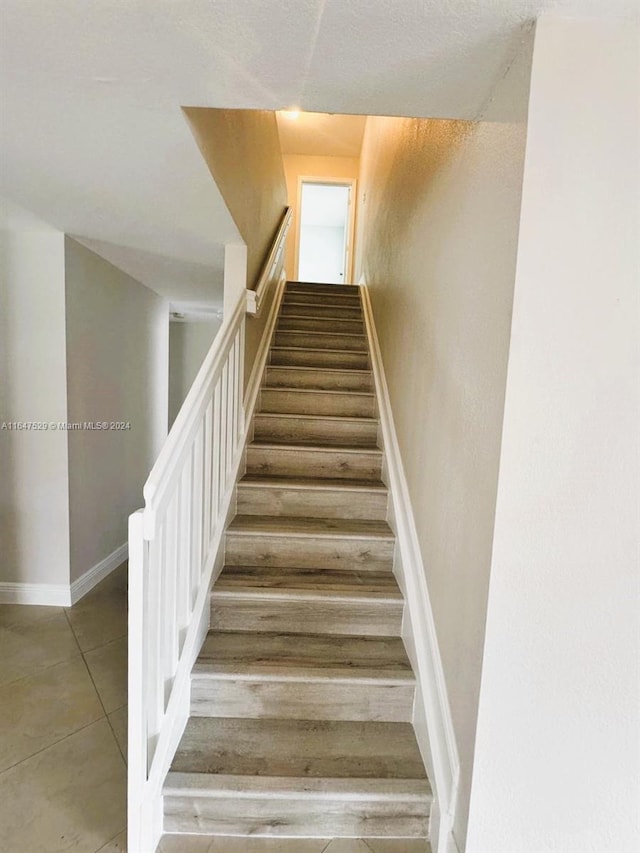 stairs featuring hardwood / wood-style flooring