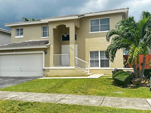 view of front of property with a front lawn and a garage