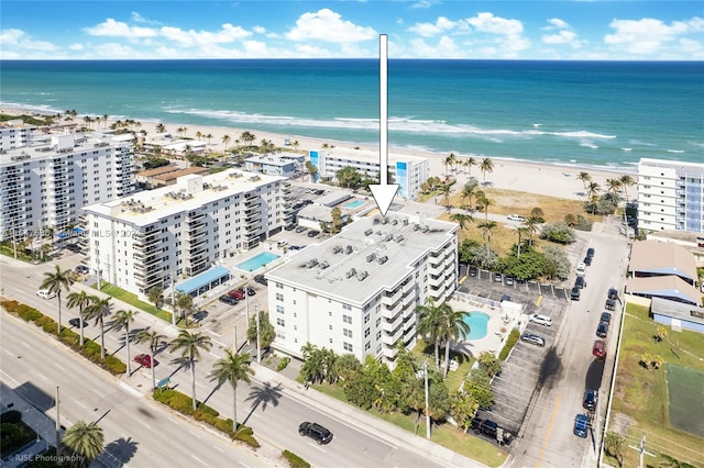 bird's eye view featuring a water view and a view of the beach