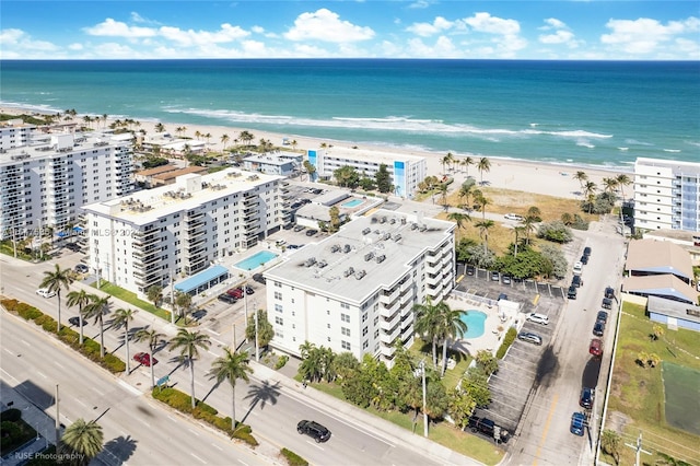 drone / aerial view with a city view, a view of the beach, and a water view