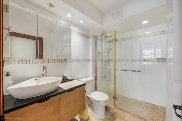 full bathroom featuring visible vents, a shower stall, toilet, decorative backsplash, and tile walls