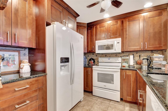 kitchen with ceiling fan, white appliances, dark stone counters, and decorative backsplash