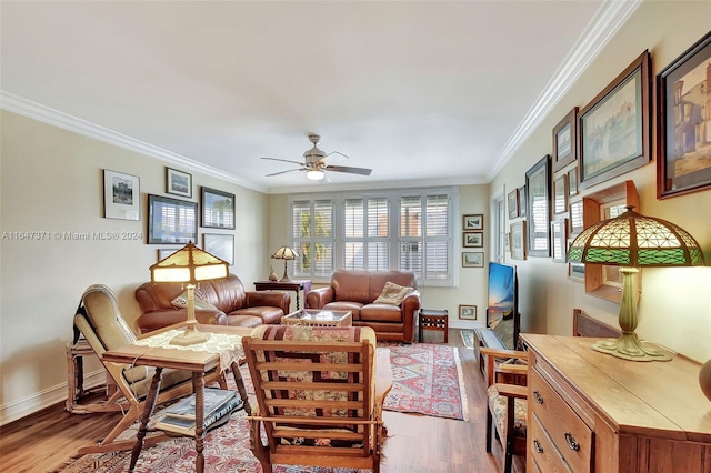 living room with wood-type flooring, crown molding, and ceiling fan