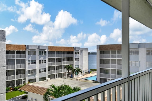 exterior space featuring a community pool and a water view