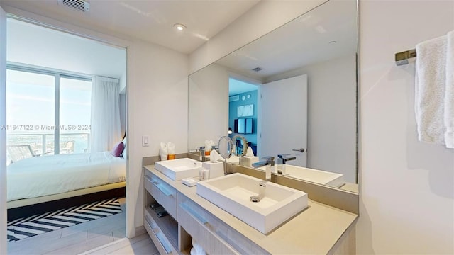 bathroom featuring tile patterned flooring and vanity