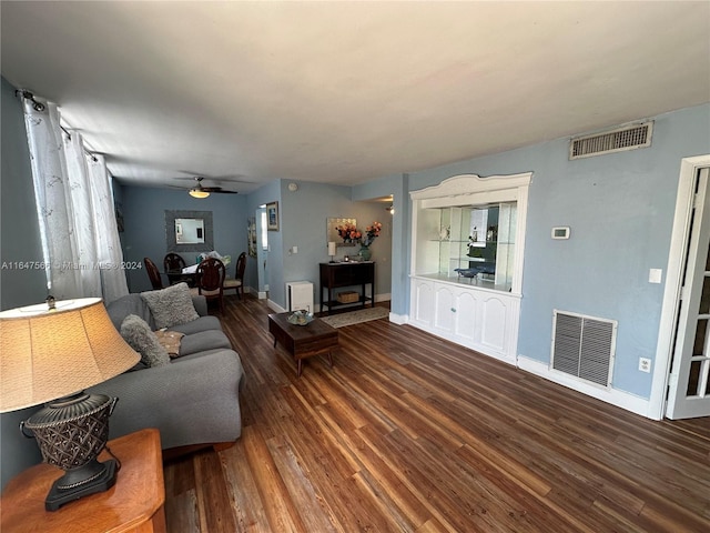 living room featuring ceiling fan and wood-type flooring